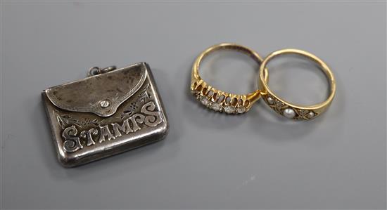 A George V 18ct gold and graduated five stone diamond half hoop ring, one other gem set ring and a silver stamp case.